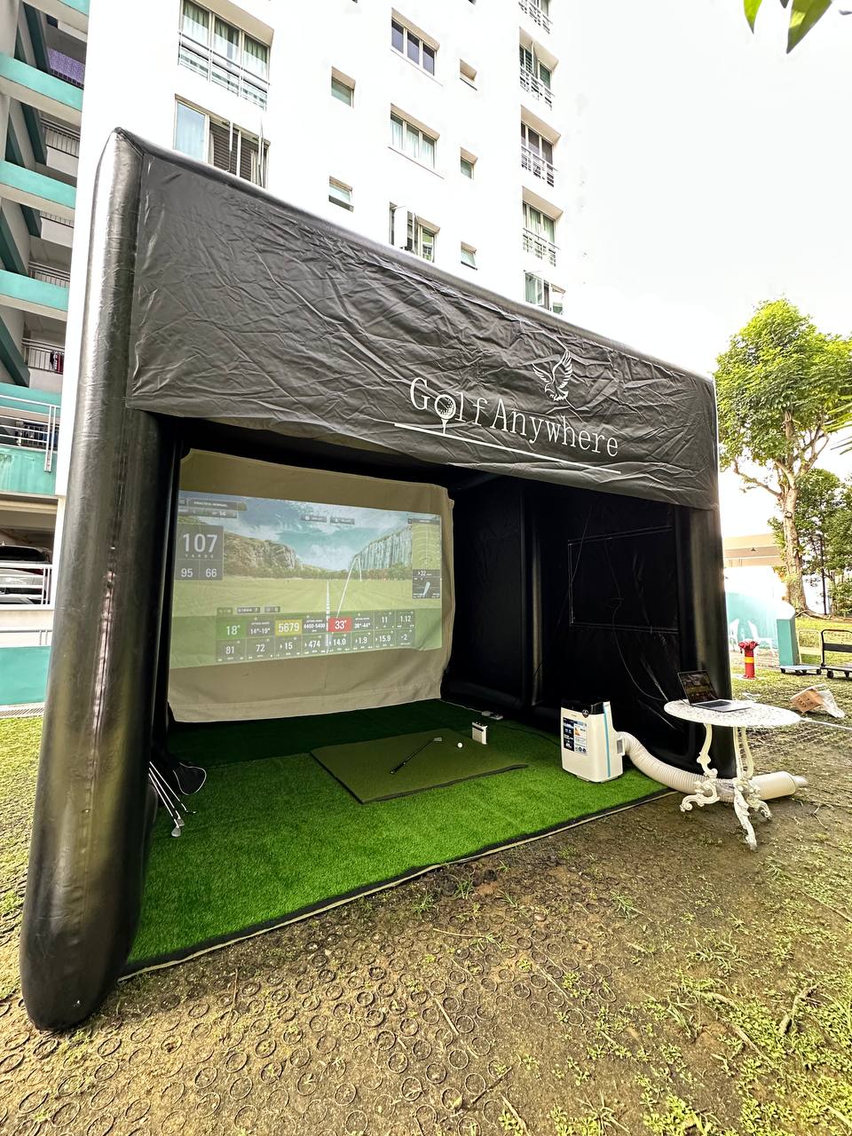 Golf Anywhere tent fully deployed outdoors at a Singapore residential event